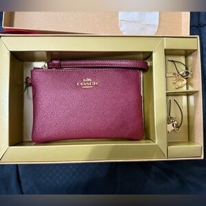 NEVER USED, Coach purple sparkle wrist wallet with charms, gift box included